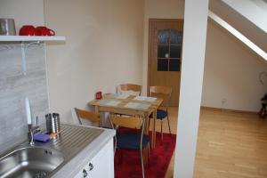 a kitchen with a table and chairs in a room at RENMIR in Poprad