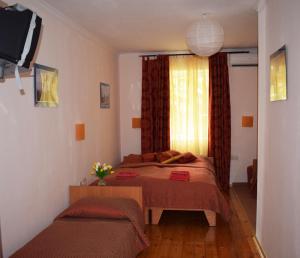 a bedroom with a bed and a window at Meraba Guest House in Bakhchysarai