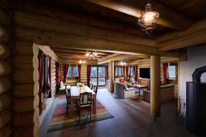 a dining room and living room in a log cabin at High Tatras Chalet in Štrbské Pleso