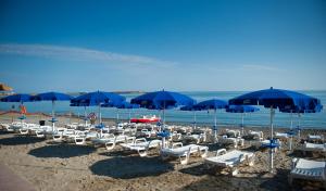 a group of chairs and umbrellas on a beach at B&B Gattopardo in Cariati