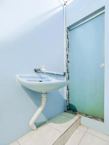 a bathroom with a sink and a mirror at OYO 90009 Faster Inn 1 in Medan