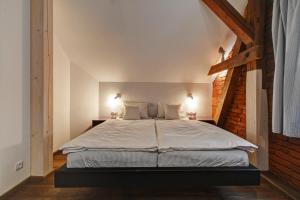 a bedroom with a large bed with a brick wall at Statek Salajna in Salajna