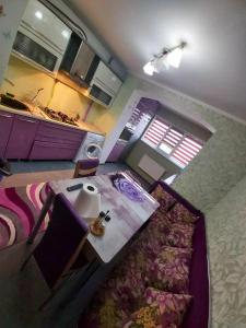 an overhead view of a kitchen with a table and a bed at Svetlana Apartment in Chişinău