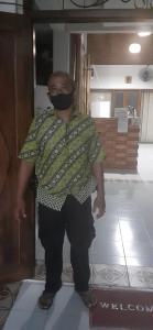 a man wearing a mask standing in a room at Griya Jagadhaya in Bantul