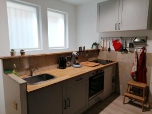 a kitchen with white cabinets and a sink at Charme et originalité en hypercentre in Tours
