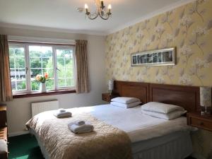 A bed or beds in a room at Distillery Guest House