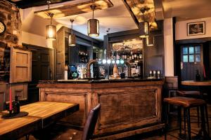 a bar in a pub with a wooden counter at The Brown's Hotel in Laugharne