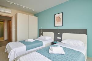 Posteľ alebo postele v izbe v ubytovaní Tiffany Apartments