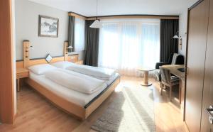 Gulta vai gultas numurā naktsmītnē Hotel Garni Aurora