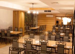 uma sala de jantar com mesas e cadeiras de madeira em Hotel Fero Lux em Korbielów
