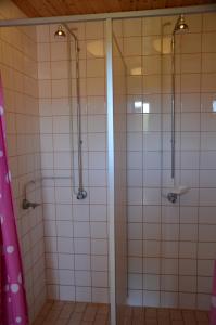 a bathroom with a shower with white tiles at Käringsund Resort Camping in Eckerö