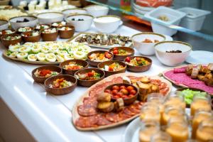a buffet with many different types of food on a table at Paradise Park Fun Lifestyle Hotel in Los Cristianos