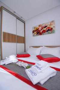 two beds with towels on them in a room at Time Out Lux apartmani in Zlatibor +24 photos