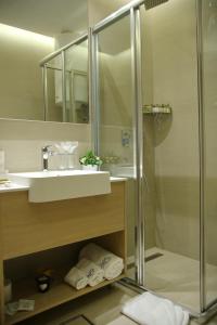 a bathroom with a sink and a shower at Time Out Lux apartmani in Zlatibor