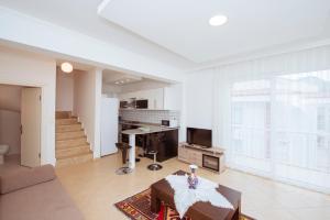 a large living room with a couch and a table at Infinity Olympia Apartments in Oludeniz