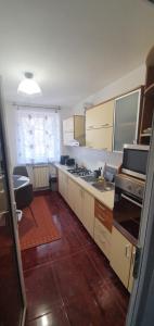 a kitchen with a sink and a stove top oven at Apartament Chaplins 3 camere in Piatra Neamţ