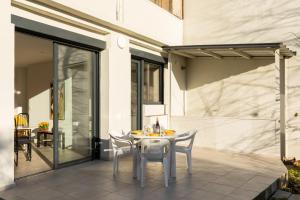 a white table and chairs on a patio at DIFY Stoppa - Lyon Parilly in Vénissieux