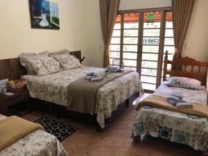 Cama ou camas em um quarto em Sítio Flora Rei