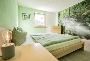 a bedroom with a bed and a table with a lamp at Ferienwohnung mit Terrasse in Steinach am Brenner