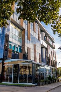 an office building with a large glass facade at Hotel IN in Banja Luka