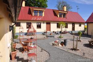 a house with a lot of animals in front of it at Hylteberga Gård Bed & Breakfast in Skurup