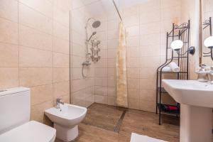 a bathroom with a toilet and a sink and a shower at Alessia Homes Coressi in Braşov