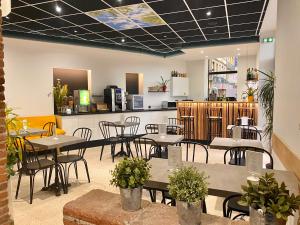 a restaurant with tables and chairs and a counter at Hotel de Bordeaux in Toulouse