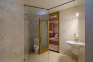 a bathroom with a shower and a toilet and a sink at Nipola Hotel - Chợ Đêm Dương Đông Phú Quốc in Phú Quốc