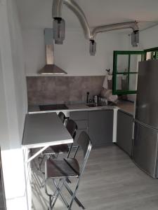a kitchen with a table and chairs and a refrigerator at Casa Rey in Playa Blanca