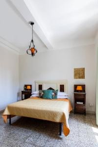 ein weißes Schlafzimmer mit einem Bett und einem Kronleuchter in der Unterkunft B&b San Rocco in Celleno