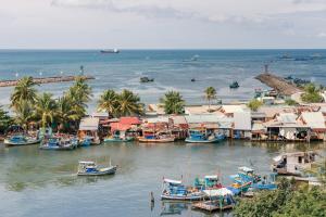 a group of boats are docked in the water at Nipola Hotel - Chợ Đêm Dương Đông Phú Quốc in Phú Quốc