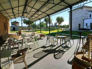 un patio al aire libre con mesas y sillas y un edificio en Manoir du Marquis de Montcalm, en Vestric-et-Candiac