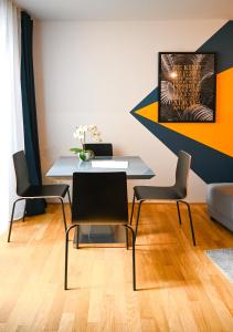 een eetkamer met een tafel en vier stoelen bij Elegant Apartment Naschmarkt in Wenen
