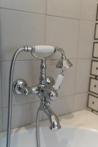a shower faucet on a tub in a bathroom at Golfo dei Poeti Retreat in La Spezia