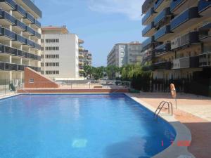 a large swimming pool in the middle of some buildings at Apartamentos Inbesal in La Pineda