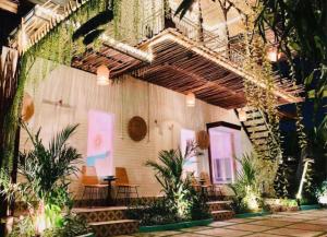 a building with a bunch of plants and a staircase at NIKINIKO Beach House by Lolavillas - 100mts to the beach in Canggu