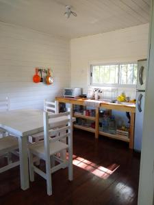 a kitchen with a table and a table and chairs at Los Sauces in Tigre +21 photos