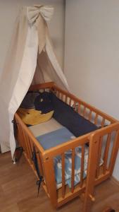 a wooden crib with a canopy in a room at Haus-Born-Simon in Treis-Karden