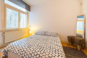 a bedroom with a large bed and a window at Charming apartment in city center in Amsterdam