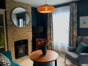 a living room with a vase of flowers on a table at Boutique home near Chichester centre in Chichester