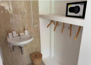 a bathroom with a sink and a microwave on a wall at NIKINIKO Beach House by Lolavillas - 100mts to the beach in Canggu +31 photos