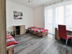 een kamer met een bed, een bureau en een stoel bij byt s balkonem in Žatec