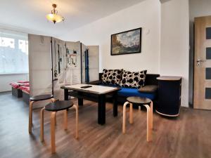 a living room with a couch and a table and chairs at byt s balkonem in Žatec