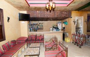 a living room with red chairs and a fireplace at El Kantaoui Center in Sousse