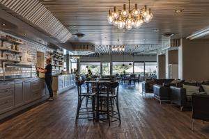 Eine Frau, die an einem Tresen in einem Restaurant steht. in der Unterkunft Apple Hotel & Konferens Göteborg in Göteborg