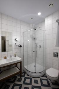 a bathroom with a shower and a toilet and a sink at Four Rooms City in Kharkiv +69 photos