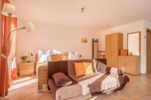 a living room with a couch and a bed at Ferienhof Sauter Lindau in Neukirch