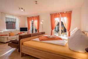 a bedroom with a bed and a living room at Ferienhof Sauter Lindau in Neukirch