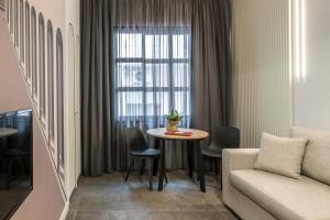 a living room with a table and a couch at Domus Ariadne in Heraklio