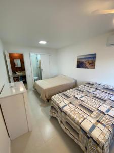 a bedroom with two beds and a sink in it at Lindo apto em Arraial do Cabo condomínio Golden Lake in Arraial do Cabo +61 photos